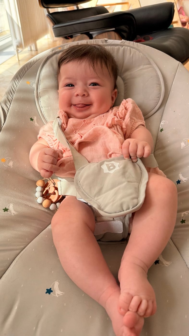 Smiling baby resting in a seat